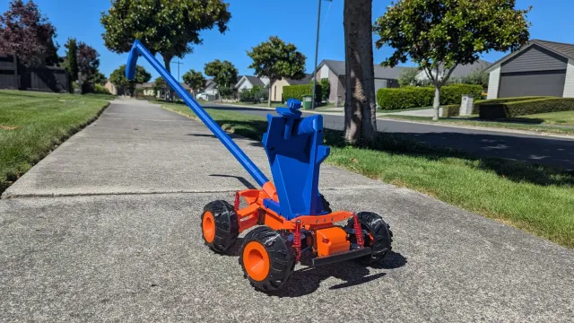 The blue and orange Access Cart on a residential footpath